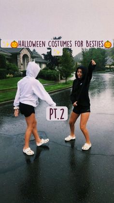 two women standing in the rain holding up signs