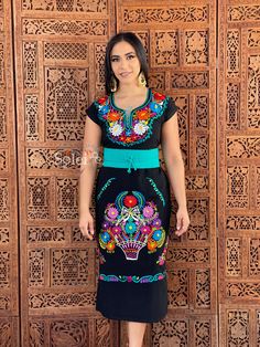 -This Beautiful Long Mexican Colorful Floral Dress is the perfect dress for a fun night out or a special event. -It is full of colorful embroidered flowers and has some crocheted details. -This dress has ties on the back in order to adjust the fit. - You can purchase the dress either with or without the belt. Please note: The accesories shown with this dress may purchased as well and Can be found in this links Earrings:https://www.etsy.com/es/listing/855938626/aretes-mexicanos-de-filigrana-arete Fitted Blue Fiesta Dresses, Blue Fitted Dress For Fiesta, Fitted Blue Dress For Fiesta, Black Embroidered Short Sleeve Maxi Dress, Embroidered Black Maxi Dress With Short Sleeves, Black Short Sleeve Embroidered Maxi Dress, Fitted Multicolor Embroidered Maxi-length Dress, Fitted Black Dress For Fiesta, Traditional Black Fiesta Dress