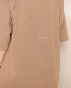 T-shirt by Acne Studios in taupe brown. Oversize tee with dropped shoulders and wide-banded crewneck. Minimally detailed with a clear logo tab at the centre rear. A staple piece in neutral tones reserved for contemporary or conservative styling. 100% Cotton.Made in Portugal. Pictured with Shield Sunglasses, Henna Bias Skirt and Mustard Low Sneakers by Rick Owens. Bias Skirt, Brown T Shirt, Oversize Tee, Kiko Kostadinov, Christian Wijnants, Brown Tshirt, Unisex Dress, Shield Sunglasses, Mm6 Maison Margiela