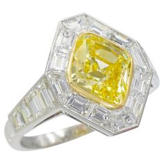 Nally Jewels Intense Fancy Yellow GIA certified Diamond Ring Diamond, Gold and Platinum Mounting. This ring has 18 step cut diamonds weighing a total of 1.87 tcw all bezel set in platinum with a center diamond of 2.05 carat rhomboid brilliant diamond (Color: Fancy Intense Yellow, Clarity: VVS2, GIA#xxxxxxxxx) bezel set in 18k yellow gold. Finger size: 6.5 ( resizable) Step Cut, Modern Ring, Diamond Gold, Fine Jewels, Ring Diamond, Color Ring, Diamond Color, Brilliant Diamond, Gia Certified Diamonds