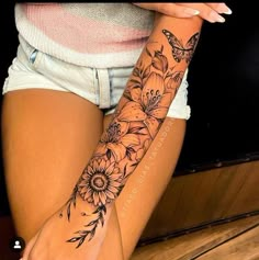 a woman's arm with flowers and butterflies tattooed on the left side of her body