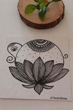 a piece of paper with an image of a flower on it next to a plant