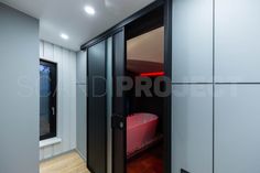 an empty bathroom with a pink tub in the corner and wood flooring on the other side