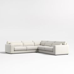 a white sectional sofa sitting on top of a white floor