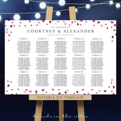 the wedding seating chart is displayed on a easel with string lights in the background