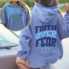 Introducing our inspiring "Faith Over Fear" hoodie, designed to uplift and encourage. This cozy hoodie features a meaningful symbol on the front, representing "God Is Greater than the Highs and Lows," reminding you of God's constant presence in every situation. On the back, the empowering phrase "Faith Over Fear" is paired with Psalm 34:4: "I sought the Lord, and he answered me; he delivered me from all my fears." Wear this hoodie to stay warm and share a message of faith, courage, and divine re Inspirational Hooded Sweatshirt For Fall, Inspirational Hooded Fall Sweatshirt, Inspirational Hoodie Sweatshirt For Fall, Inspirational Fall Hoodie Sweatshirt, Inspirational Graphic Print Hoodie For Fall, Inspirational Letter Print Hoodie For Fall, Inspirational Long Sleeve Relaxed Fit Hoodie, Inspirational Hooded Sweatshirt With Letter Print, Inspirational Hooded Hoodie With Letter Print