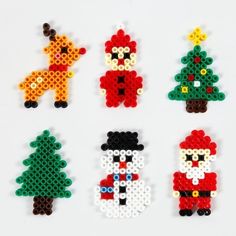 christmas ornaments made out of legos on a white surface