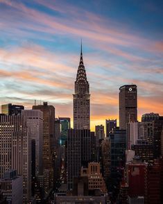 the empire building towering over new york city at sunset