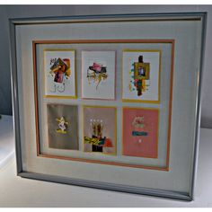 a framed art piece with different pictures on it