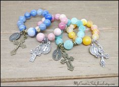 Four variations available of a one decade finger rosary. Each is made with ten 8mm and one 10mm gemstone beads, metal beads, metal charm and a metal cross. Stretches to comfortably fit over any finger to be held in the palm of the hand. A sweet gift idea. Blue Aventurine with antiqued gold accents.  *Aventurine is known as the "Stone of Opportunity" and has been said to help bring luck and prosperity. Pink Rhodonite  with antiqued silver accents *Rhodonite is known as the "Rescue Stone" as it is said to help with emotional healing. Green Agate with antiqued gold accents. *Agate is said to be a stone that helps to balance energy and encourage self-confidence. Yellow Agate with antiqued silver accents. *Agate is said to be a stone that helps to balance energy and encourage self-confidence. F Gemstone Beads Rosary As Gift, Traditional Gemstone Beads Rosary As Gift, Pink Rosary With 8mm Beads As Gift, Multicolor Hand-strung Rosary Bracelet Gift, Cross-shaped Rosary Bracelet With 8mm Beads, Meditation Cross-shaped Beaded Rosary, Sweet Gift Ideas, Metal Cross, Green Agate