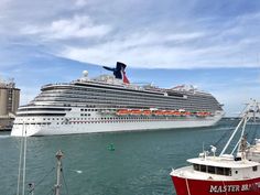 a large cruise ship in the water next to a dock