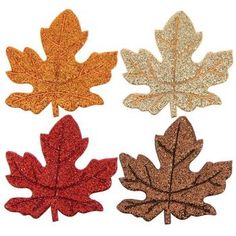 four different colored leaves with glitter on them