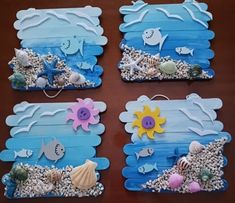 four pieces of art made to look like seashells and sea animals on wood planks