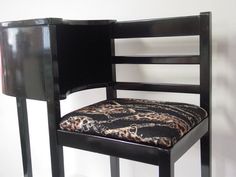 a black chair with a leopard print seat pad on it's armrests