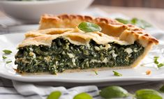 a slice of spinach pie on a white plate