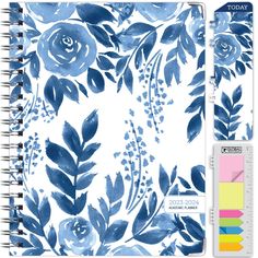 a spiral notebook with blue flowers and leaves on the cover, surrounded by color swatches