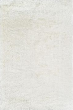 an area rug with white fur on it