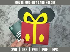 a hand holding up a mickey mouse gift card holder