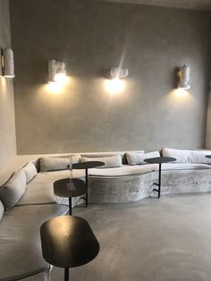 a living room filled with lots of furniture and lights on the wall next to each other