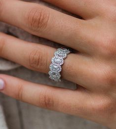 a woman's hand with a diamond ring on it