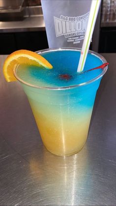 a blue and yellow drink sitting on top of a table