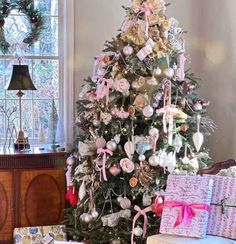 a decorated christmas tree in a living room with presents on the floor next to it