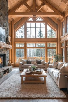 a living room filled with furniture and a fire place in front of a large window