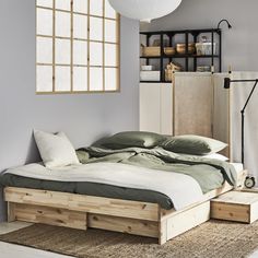 a bed sitting on top of a wooden platform