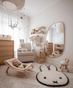 a baby's room with an animal rug, rocking chair and teddy bear bed