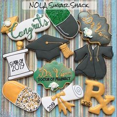 graduation cookies are arranged in the shape of hats, gowns, and diploma caps