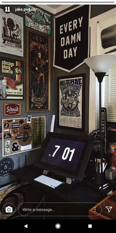 a desktop computer sitting on top of a wooden desk next to a lamp and pictures