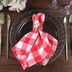 a place setting with red and white napkins