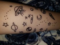 a person with a tattoo on their arm that has planets and stars all over it