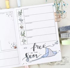 an open planner with the words free as the sea written on it, next to other items