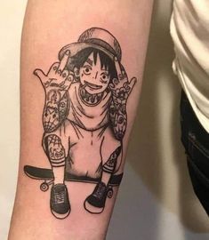 a person with a tattoo on their arm holding a skateboard and wearing a hat