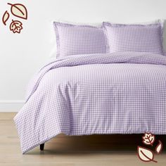 a bed with purple and white checkered sheets