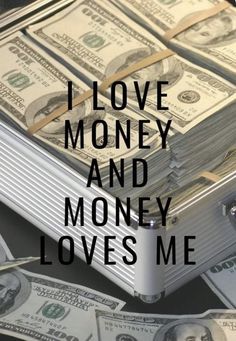 the words i love money and money loves me on top of stacks of hundred dollar bills