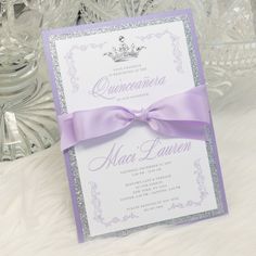 a purple and silver wedding card with a ribbon