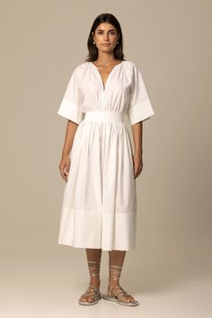 Made of Italian certified organic cotton fabric, the Ania dress in crisp white is inspired by the aesthetic of traditional Romanian peasant dresses. Featuring a relaxed top with gathered neckline and sleeves, a full skirt with concealed zipper closure, side seam pockets and elasticized waistband at the back, the result is a flattering and timeless silhouette. Beautifully crafted inside and out, the dress is perfect for long summer days and beyond. Fit: Bianca, our model is 5.8” or 1.77m tall and Simple White Cotton Dress, White Poplin Dress, Peasant Dresses, Russian Dress, Wash And Fold, Gathered Neckline, White Cotton Dress, Cotton Shirt Dress, Poplin Dress