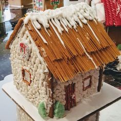 a gingerbread house with white icing on top