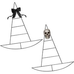 a skull sitting on top of a boat next to a black and white drawing of a sailboat