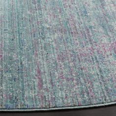 an area rug with various colors and patterns on the floor, including blue, pink, green