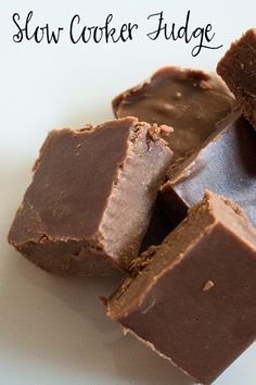 several pieces of chocolate are stacked on top of each other with the words slow cooker fudge in the background