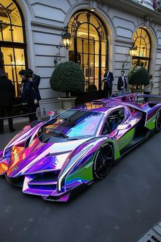 a very colorful car parked in front of a building