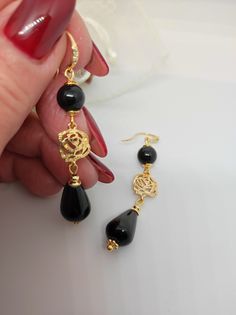 Beautiful handmade earrings with black agate beads and 18K gold plated metal components. For this creation I was inspired by the classic 50s style. I used the contrast of gold and black colors which makes the earrings very elegant. The earrings are long, very elegant and romantic thanks to the floral elements as connectors. Suitable for an elegant evening dress for an important party. They match with some long agate necklaces that I offer in my shop. All jewels are delivered in a decorated box, ready to be given as a gift to your loved one. How to take care of your jewellery: put on your beauty products (cosmetics, perfumes, ...) before wearing your precious jewel. Clean your jewelry with a soft cloth after wearing. Don't use water. Make sure you store your jewelry separately to avoid scra Black Gold-plated Pierced Earrings, Black Gold-plated Earrings, Black Gold-plated Earrings For Formal Occasions, Formal Black Gold-plated Earrings, Elegant Gold Earrings With Black Enamel, Elegant Onyx Earrings For Party, Elegant Black Bead Drop Earrings, Black Gold-plated Earrings For Gift, Gold Onyx Earrings For Evening