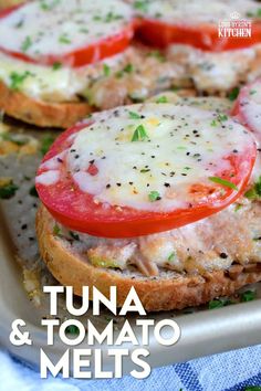 an open face sandwich with tomatoes, cheese and herbs on the top is ready to be eaten