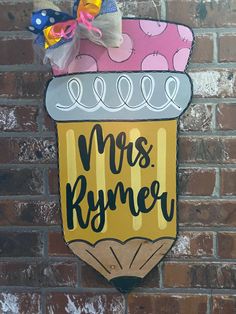 a sign on the side of a brick wall that says mrs romney with a cupcake