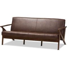 a brown leather couch sitting on top of a wooden frame