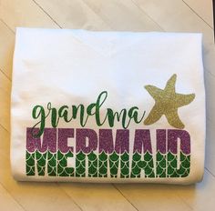 a white towel with the words grandma mermaid on it and a starfish in the background