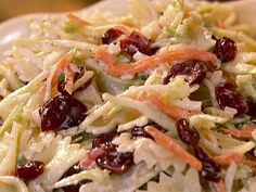 a salad with cranberries and shredded cabbage